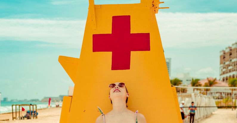 Sunglasses - Shallow Focus Photo of Woman Standing Near Lifeguard Tower