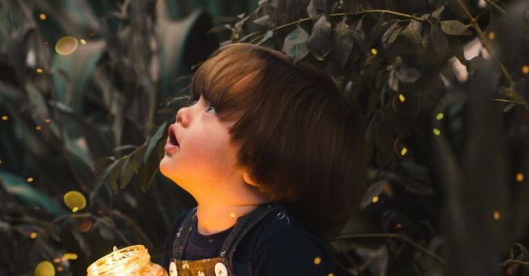 Fall Festivals - Child Holding Clear Glass Jar With Yellow Light