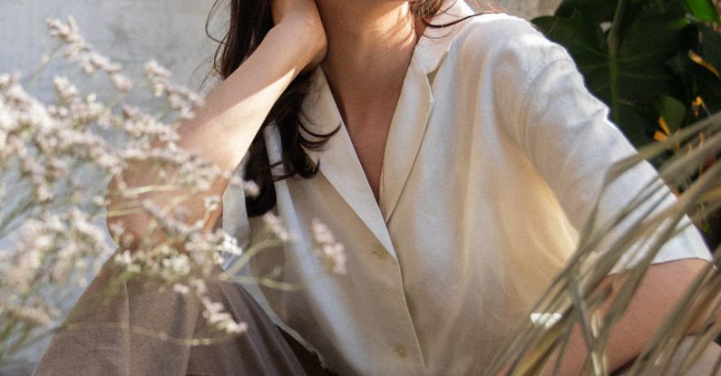 Button-Up Shirt - Woman in White Button-Up Shirt Sitting on the Ground