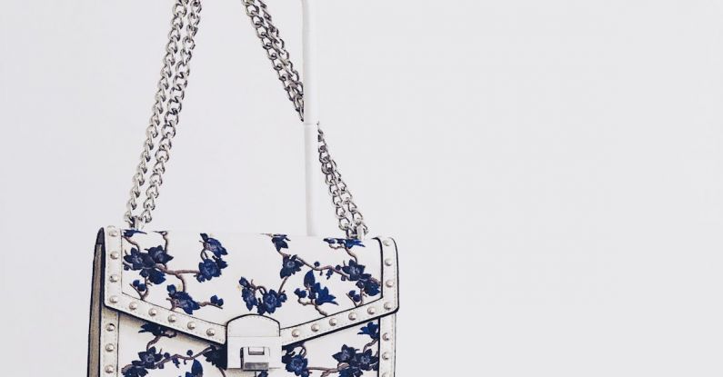 Handbags - White and Blue Floral Flap Sling Bag Hanging on White Steel Rack