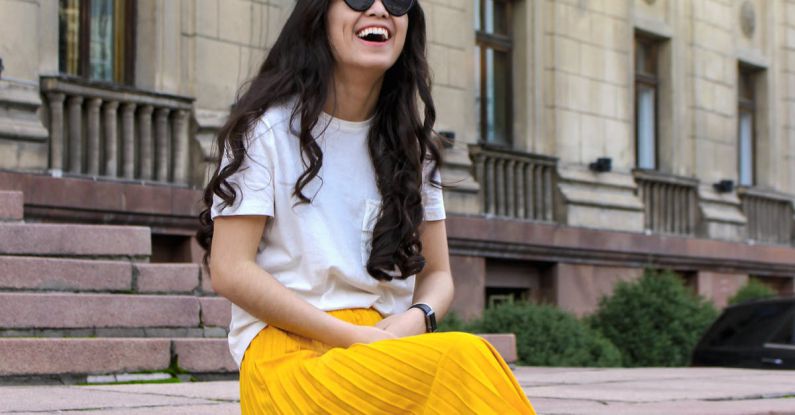 Street Style - Woman Wearing White Shirt and Yellow Skirt Sitting on Brown Concrete Brick Stairs